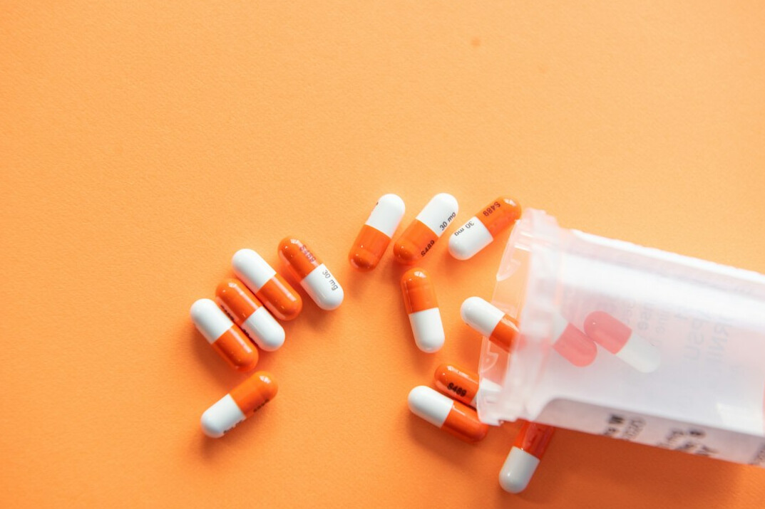 Pills and medicine capsules on a light surface
