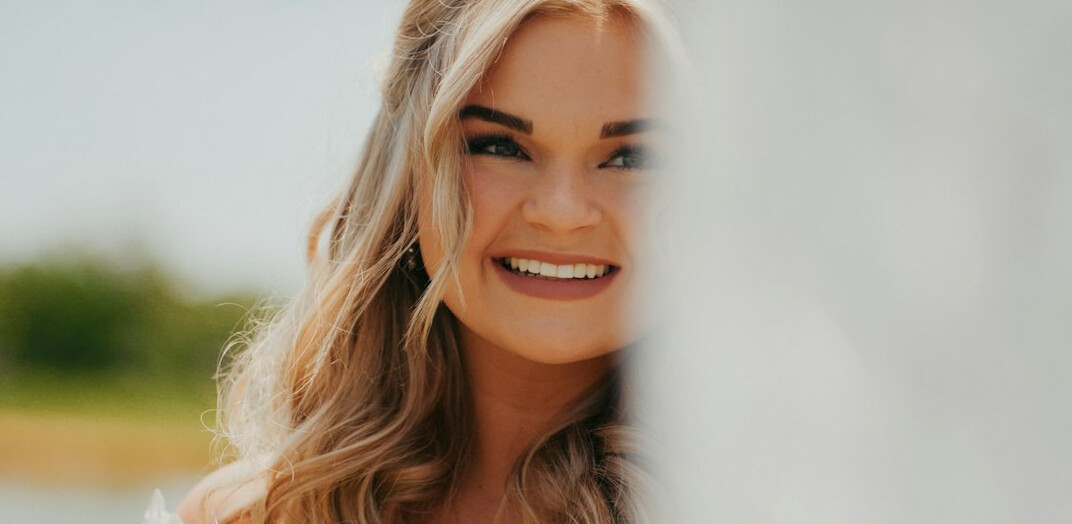 Smiling woman with long hair looking at the camera